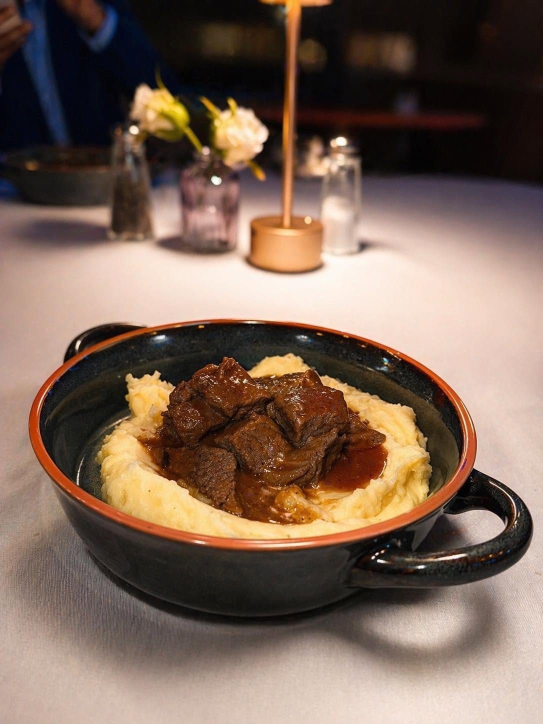 Goulash served over mashed potatoes
