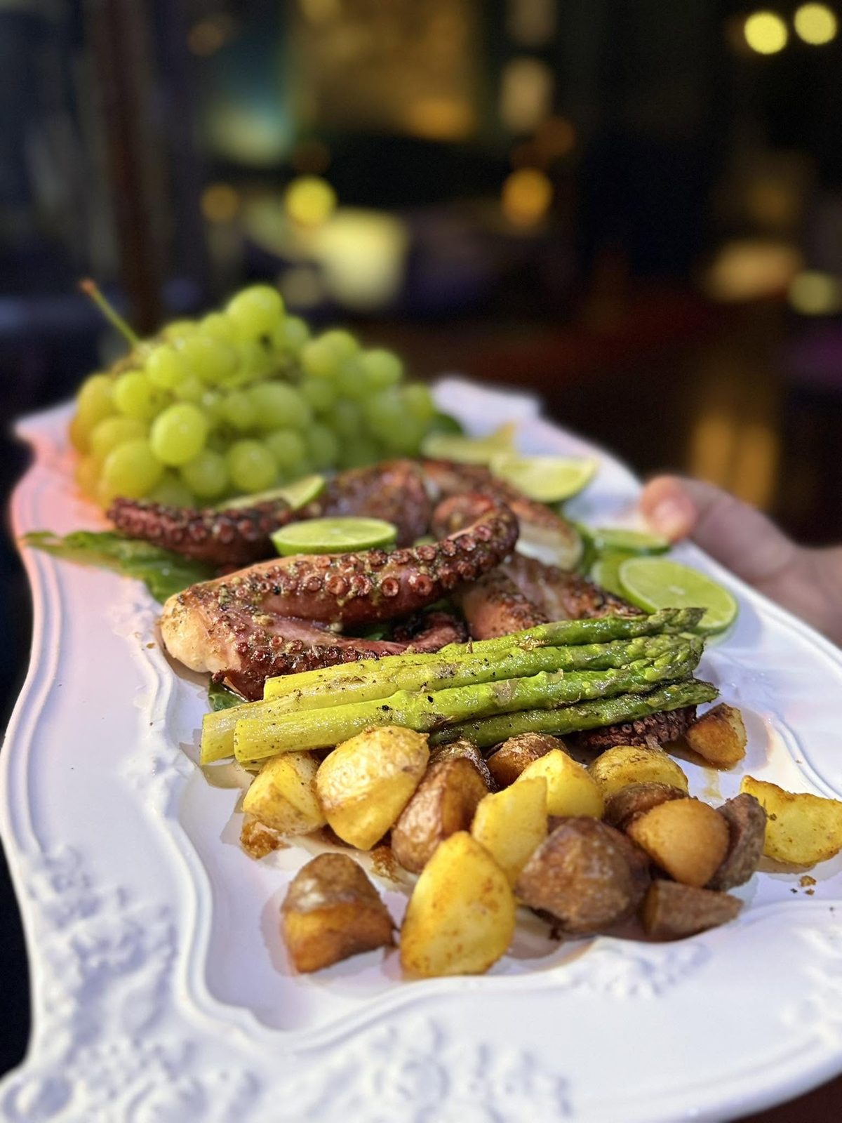 Grilled octopus platter with potatoes and asparagus